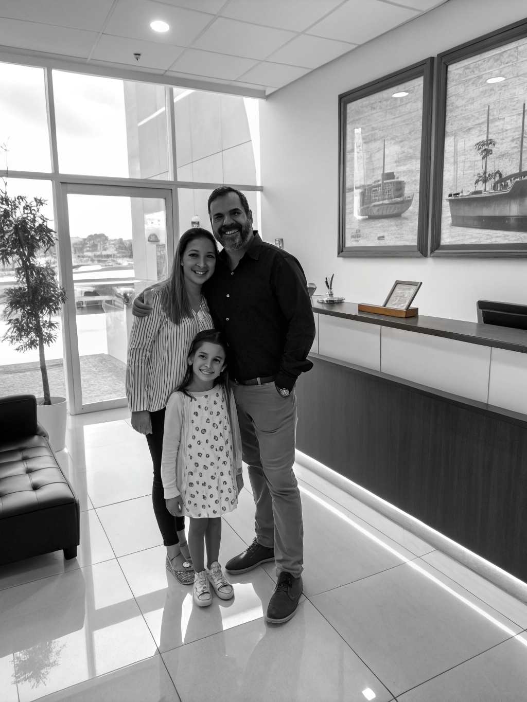Family smiling together in a bright clinic